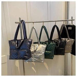 Detailed row of colorful quilted down tote bags featuring glossy nylon and padded handles
