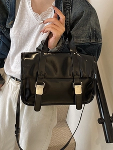 Retro black patent leather messenger bag with dual silver buckles and adjustable strap