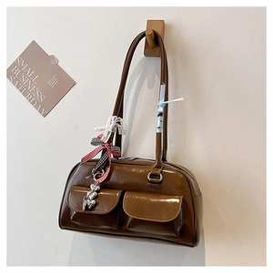 Detailansicht braune Retro-Schultertasche mit Herzanhängern und Spitzenschleife