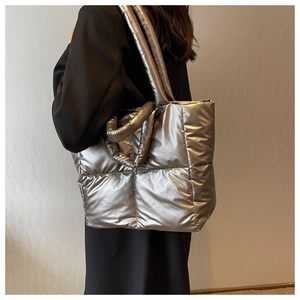 Detail view of silver metallic quilted tote bag with long and short shoulder straps