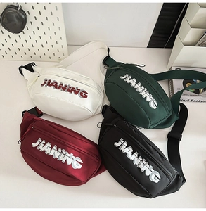 Detailed view of four colorful nylon belt bags in white, dark green, burgundy and black