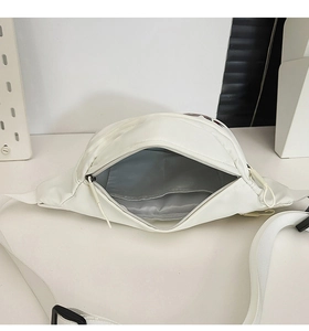Detail view of white nylon waist bag interior with grey lining and inner pocket