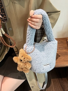 Blue plush teddy fur bucket bag with a cute bear pendant and a grey shoulder strap