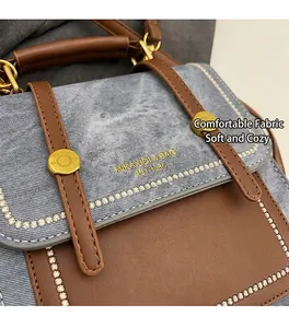 Close-up of blue washed denim and brown leather stitching with vintage star embroidery