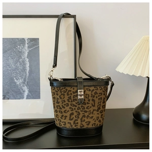 Detail of stylish leopard print bucket bag featuring premium silver twist lock and leather trim