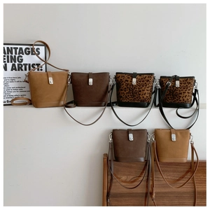 Detailed view of vintage suede bucket bags in solid colors and leopard prints