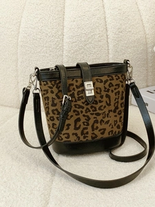 Chic leopard print bucket bag with black leather trim and silver metal twist lock