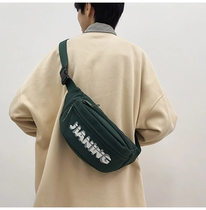 Rear view of dark green nylon crossbody bag with JIANING logo and adjustable strap