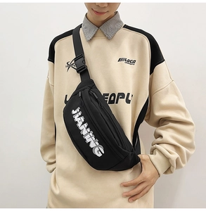 Close-up of black sports crossbody bag featuring JIANING logo and adjustable strap buckle