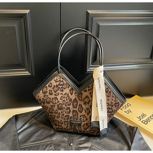 Dettaglio della borsa tote leopardata con bordo a V, spalline in pelle e logo chic