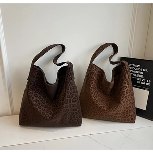 Detail of leopard print tote bag with soft suede texture and wide integrated shoulder strap
