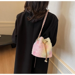 Detailed shot of pink plush bucket bag with star sequins and pearl drawstring charm