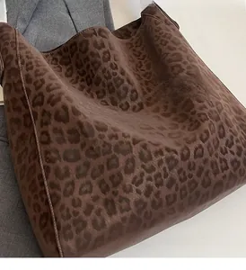 Detail of leopard print tote bag showing soft textured fabric and brown animal pattern