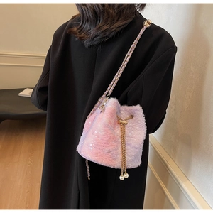 Detail of plush gradient bucket bag with faux fur, pearl drawstring, and gold chain