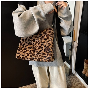 Vue détaillée du sac cabas en fausse fourrure léopard avec bandoulière en cuir noir