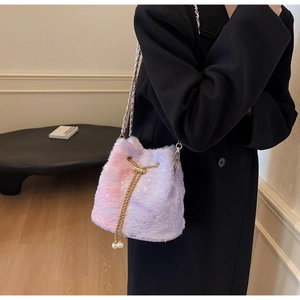 Detail of plush bucket bag featuring purple-pink gradient fur and star patterns with pearls