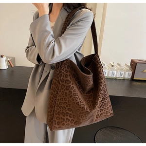 Chic leopard print tote bag styled with a gray blazer for a modern urban autumn look