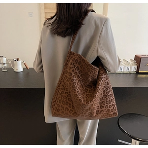 Detail view of large leopard print tote bag styled in a minimalist studio environment