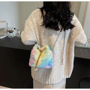 Detail of colorful plush bucket bag with golden chain and large faux pearl drawstring