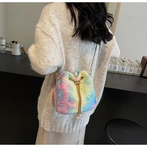 Detail shot of rainbow faux fur bucket bag with gold chain and pearl drawstring charms