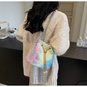 Detail of colorful plush bucket bag with chain strap and pearl drawstring accents