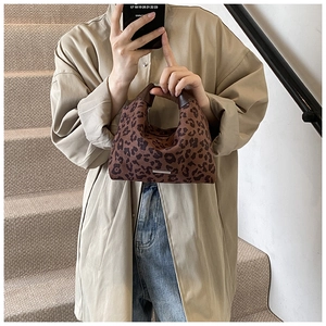 Detail der Handtasche mit Leopardenmuster, Ledergriffen und silbernen Metallakzenten