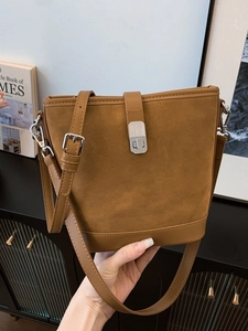 Vintage caramel brown suede bucket bag with leather trim and silver metal buckle