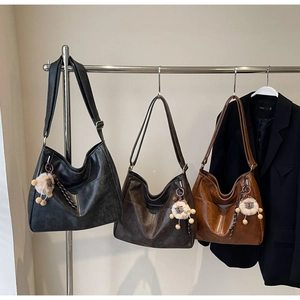 Retro large capacity tote bag displayed in black, dark brown, and caramel leather