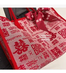 Detail shot of the woven texture and Double Happiness print on a red wedding tote bag