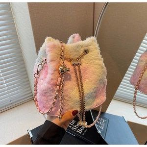 Detailed shot of plush bucket bag with gradient pastel fur and pearl drawstring tassels