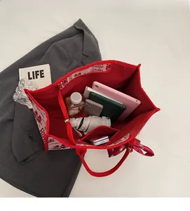 Interior detail of red bridal tote bag showing large capacity for tablet and umbrella