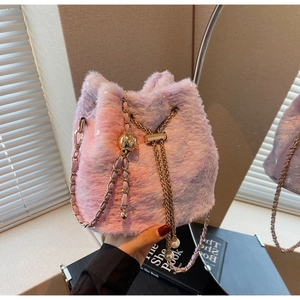 Detail of plush bucket bag featuring pink-purple gradient fur and pearl drawstring charms