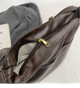 Detailed close-up of smooth golden metal zipper and durable herringbone fabric lining