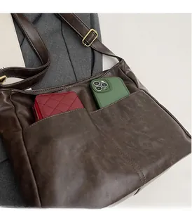 Macro detail of dark brown retro tote bag with durable outer pockets and large capacity