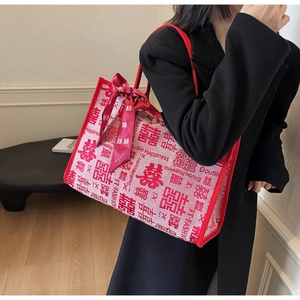 Close-up of cream canvas wedding tote bag with red Double Happiness print and bow