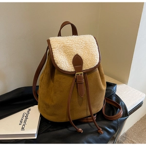 Detail of faux shearling trim and brown suede texture on vintage autumn backpack