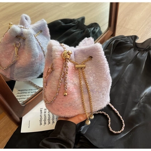 Detail of pink gradient faux fur bucket bag with gold chain and pearl drawstring charm