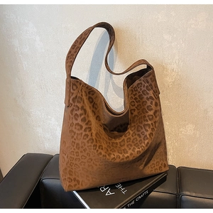 Detail of premium leopard print tote bag with soft suede texture on a leather seat