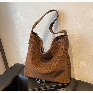Detail of leopard print tote bag with soft suede texture and wide shoulder strap