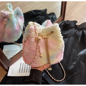 Detail of rainbow plush bucket bag featuring gold chain strap and elegant pearl charm