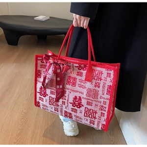 Macro view of woven red tote bag texture featuring Double Happiness letters and ribbon