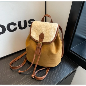Detail of caramel suede and sherpa fleece texture with drawstring closure on a backpack