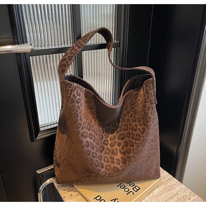 Macro detail of high-quality leopard print pattern on textured leather tote bag