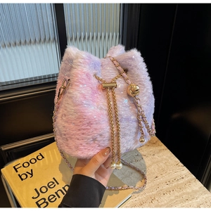 Detail of plush bucket bag featuring purple gradient fur, star patterns, and pearl charms