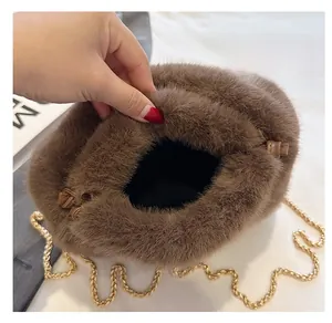 Detail of plush brown bucket bag showing drawstring closure and black interior lining