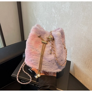 Detailed texture of pink purple gradient plush bucket bag with golden chain strap