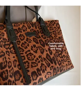 Detail of soft leopard print tote bag with comfortable fabric and black logo handle