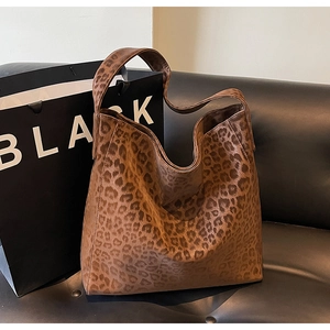 Detail of leopard print hobo bag showing suede texture and wide comfortable shoulder strap