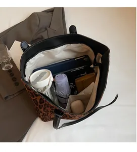 Spacious leopard print tote bag interior showing capacity for tablet and daily items