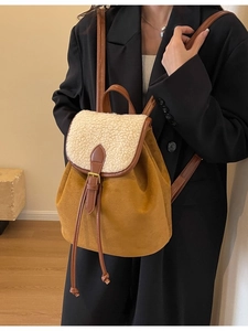 Brown suede and white shearling drawstring backpack with adjustable leather straps